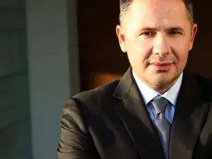 Meet Albania’s first billionaire. Once a refugee who slept in trucks, he now owns a bank. He is..