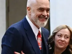 WATCH | Albanian PM goes down on one knee, surprises Giorgia Meloni with scarf on birthday