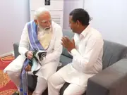 PM Modi meets Haryana admirer who vowed to stay barefoot until he became PM, helps him wear shoes-WATCH