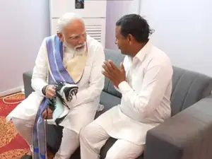 PM Modi meets Haryana admirer who vowed to stay barefoot until he became PM, helps him wear shoes-WATCH