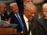 Michelle Obama was ‘furious’ to see Barack 'yukking it up' with Trump at Carter funeral: Report