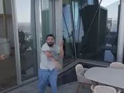 Drake aims his slipper at drone hovering around his apartment in viral video, Internet thinks it's staged