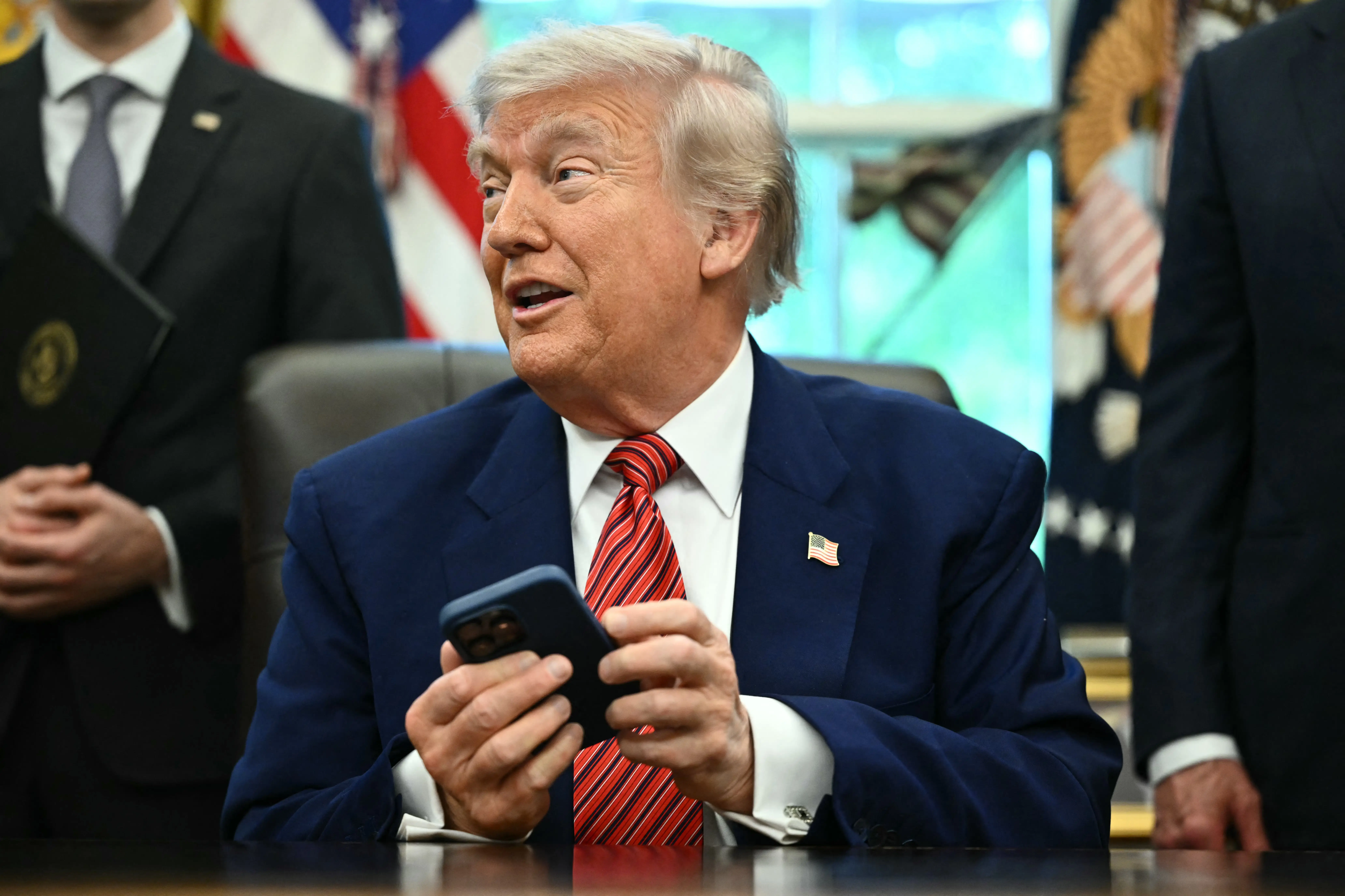 Awkward! Trump's iPhone buzzes twice during his anti-Apple rant, leaving him red-faced. Watch video