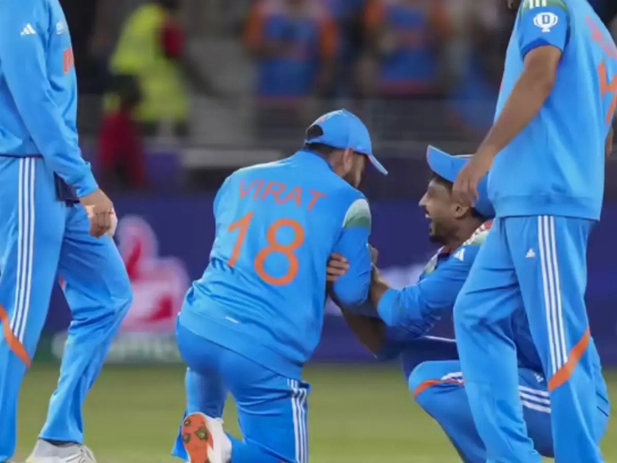 Kohli playfully touched Axar Patel's feet