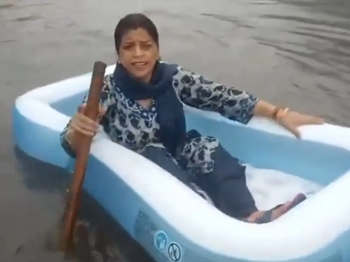 WATCH | Opposition shows grim reality to ruling BJP; woman seen rowing a ‘boat’ on waterlogged Delhi streets