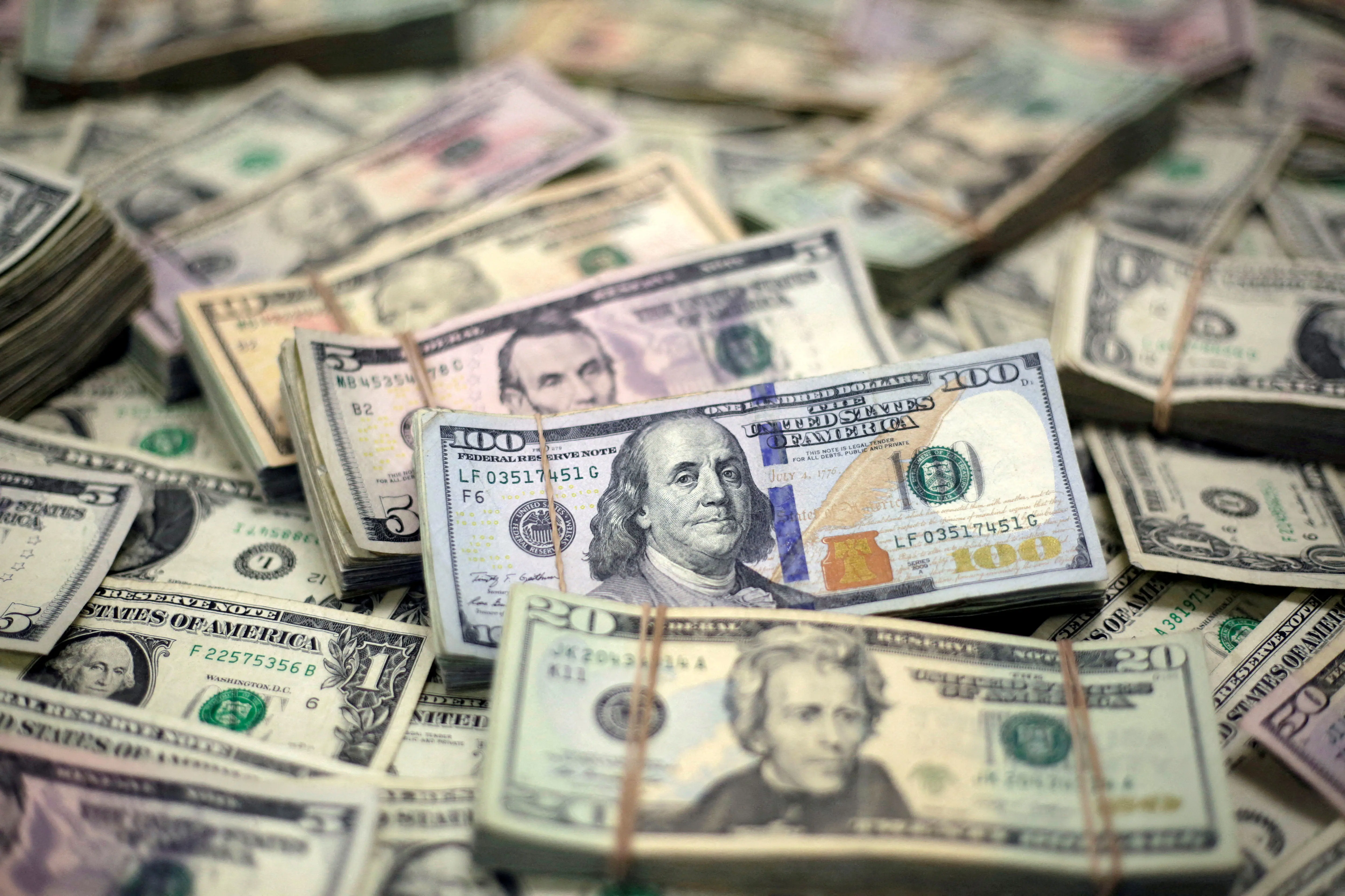 Dollar holds ground after hot US inflation data trims Fed rate cut hopes