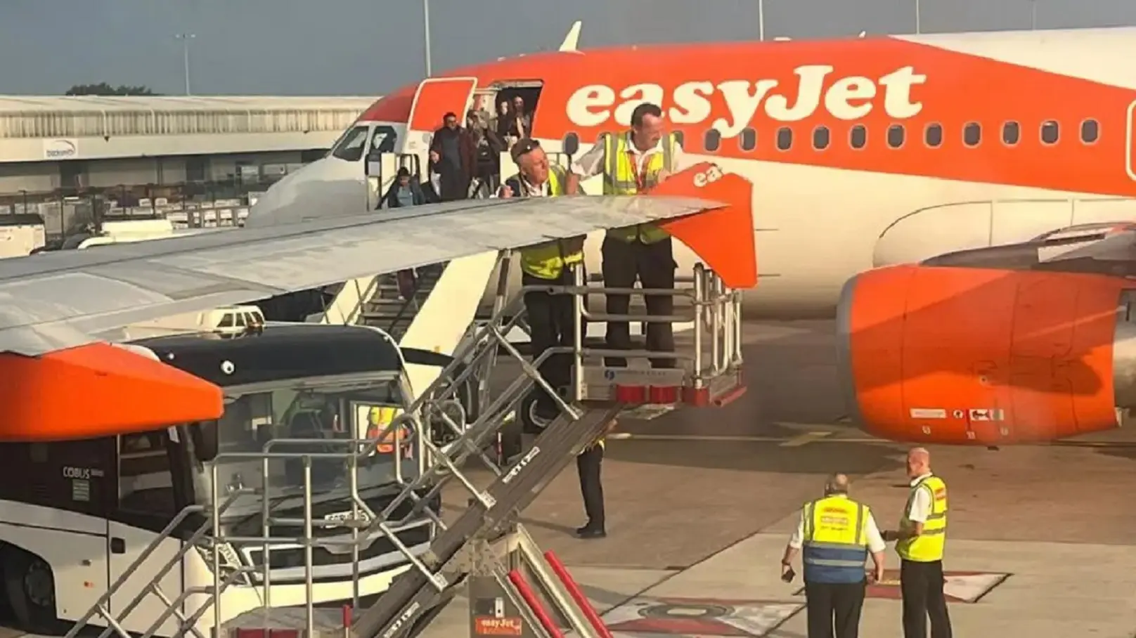 EasyJet planes taxiing for takeoff clip wings at Manchester Airport