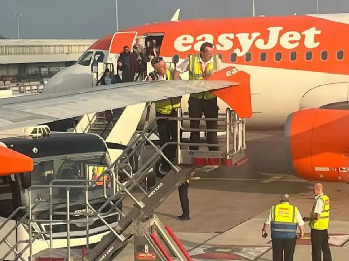 EasyJet planes taxiing for takeoff clip wings at Manchester Airport EasyJet planes taxiing for takeoff clip wings at Manchester Airport