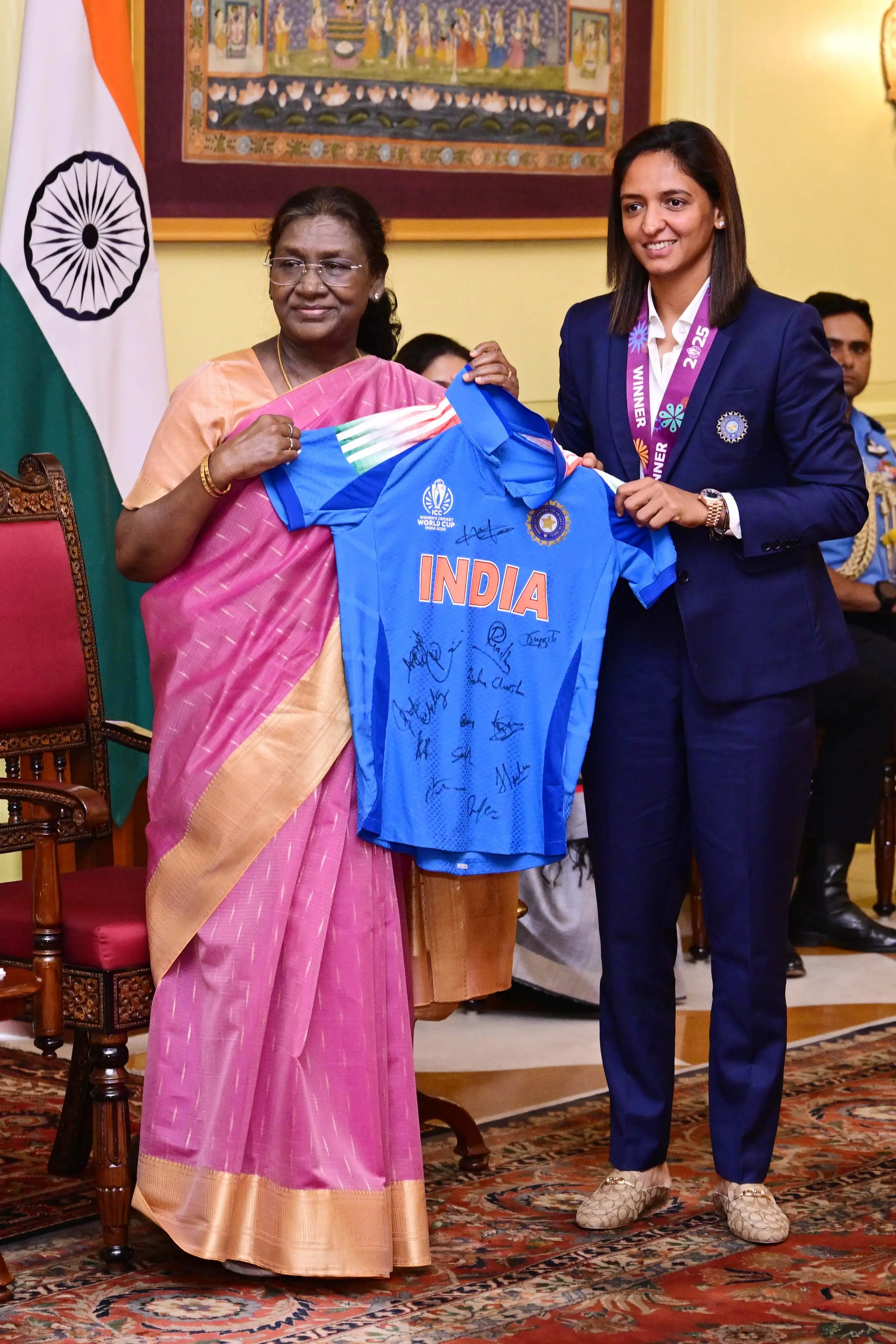 India women's team captain Harmanpreet Kaur presents President Droupadi Murmu with signed jersey