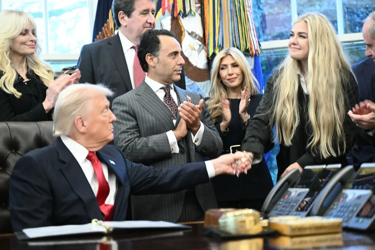 Erika Kirk and Donald Trump share a kiss during the swearing in of Sergio Gor