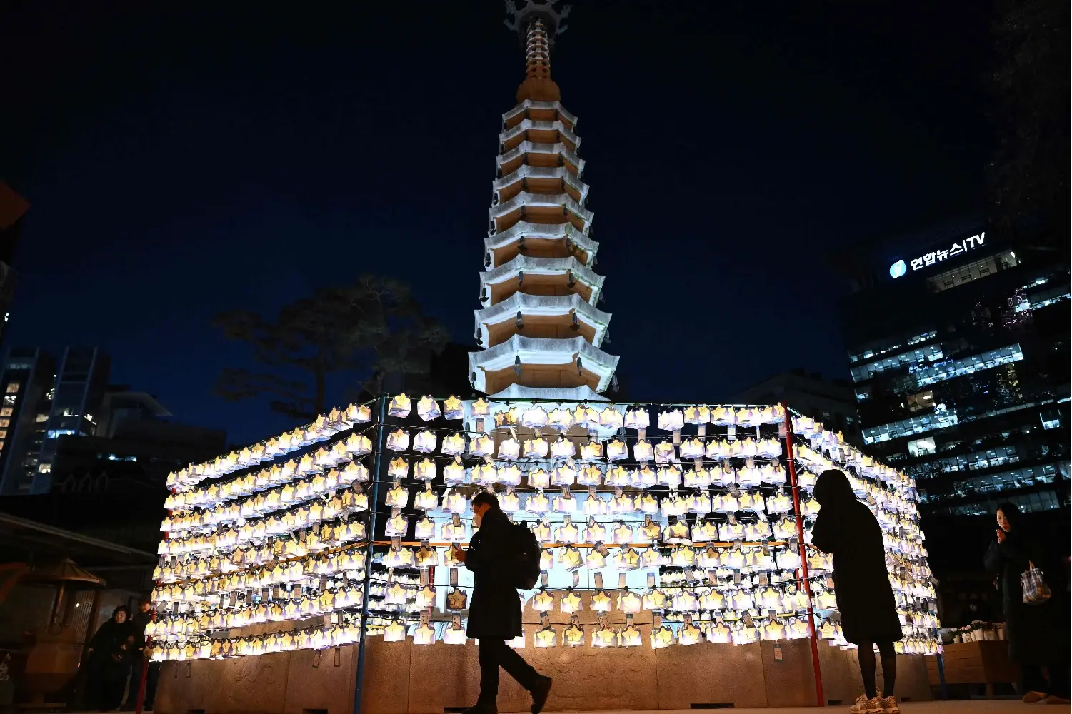 Visitors pray in front of the Jogyesa Temple in Seoul