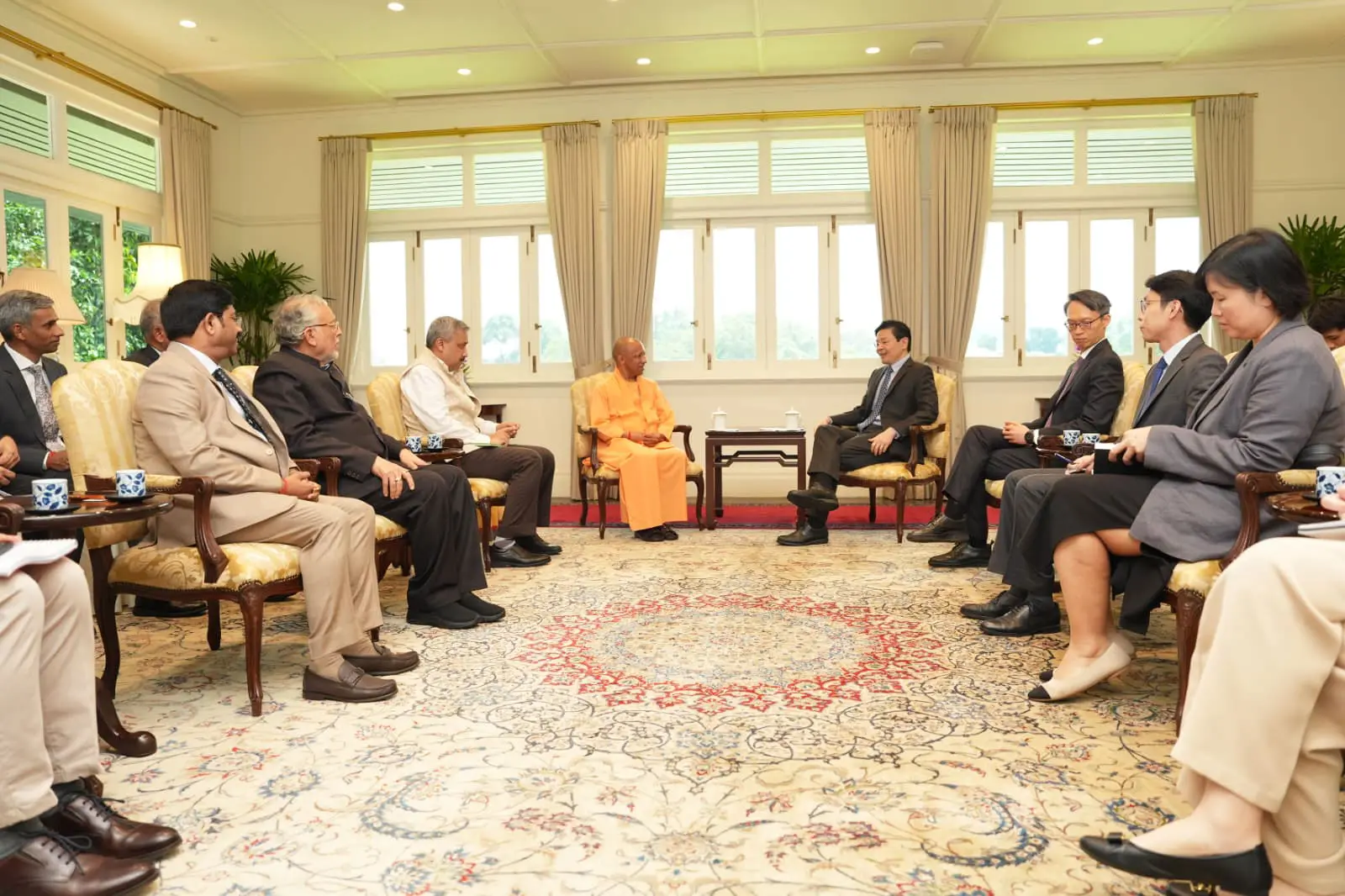 'A saffron-clad businessman': Yogi Adityanath, wearing traditional dress, meets Singapore investors