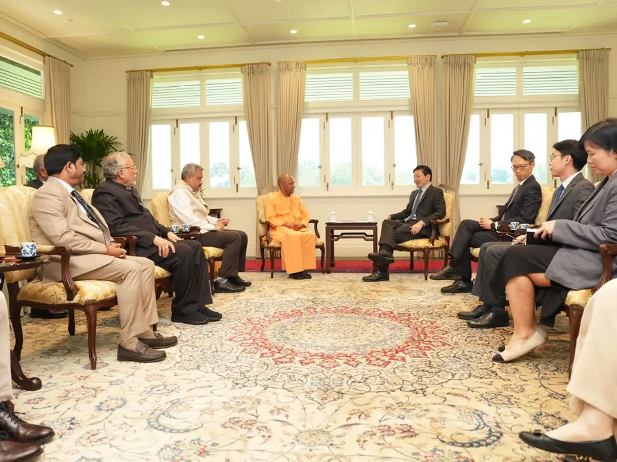 'A saffron-clad businessman': Yogi Adityanath, wearing traditional dress, meets Singapore investors