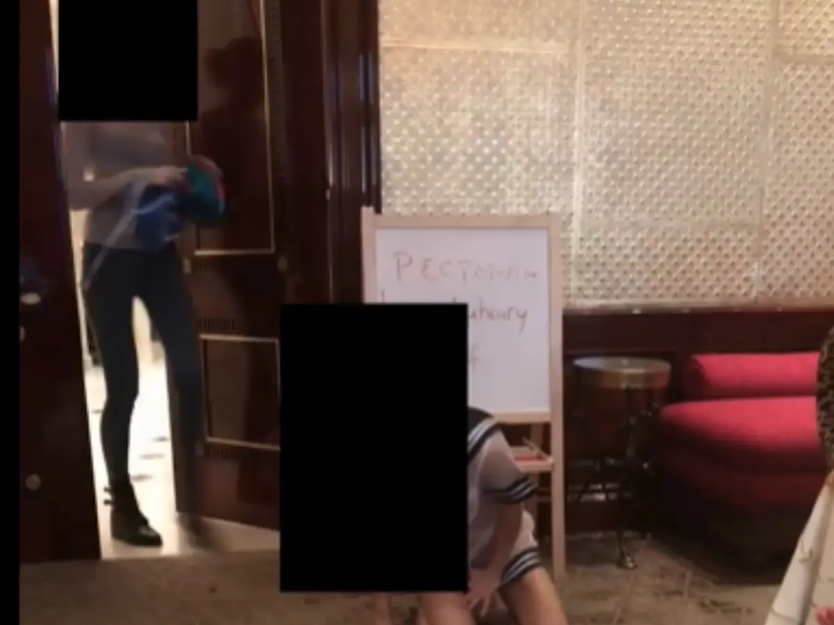 Girl kneeling in a large room