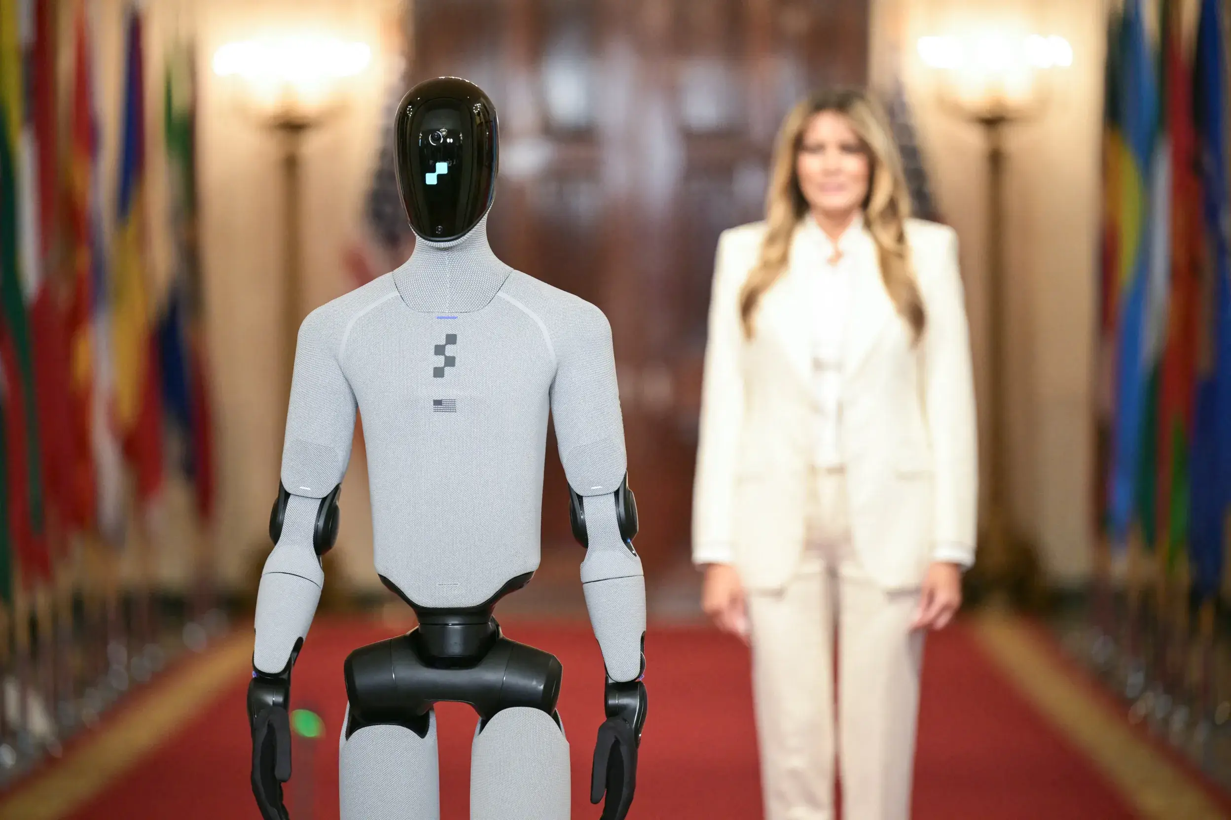 Melania Trump walks along humanoid robot Figure 03 in White House