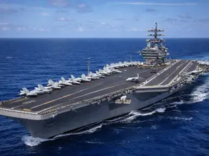 How is landing a fighter jet on USS Abraham Lincoln different from USS Tripoli?