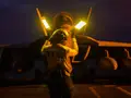 What essential hand signals are used by deck crew on USS Abraham Lincoln to avoid catastrophic errors during operations?