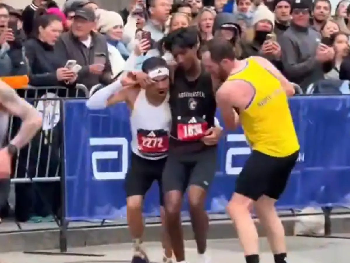 WATCH: Collapsed near finish line, two participants carry runner to complete Boston Marathon