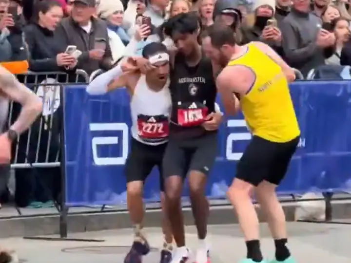 WATCH: Collapsed near finish line, two participants carry runner to complete Boston Marathon WATCH: Collapsed near finish line, two participants carry runner to complete Boston Marathon