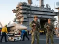 Do sailors on the USS Abraham Lincoln carry guns?
