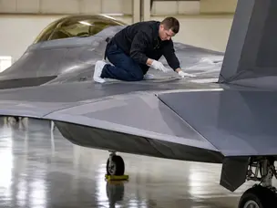 Why mechanics wear soft cloth booties when working on the F-22 fighter jet