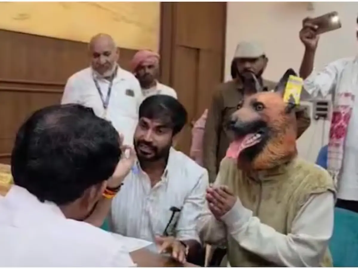 Indian politician brings man wearing dog mask to police station to protest dog menace