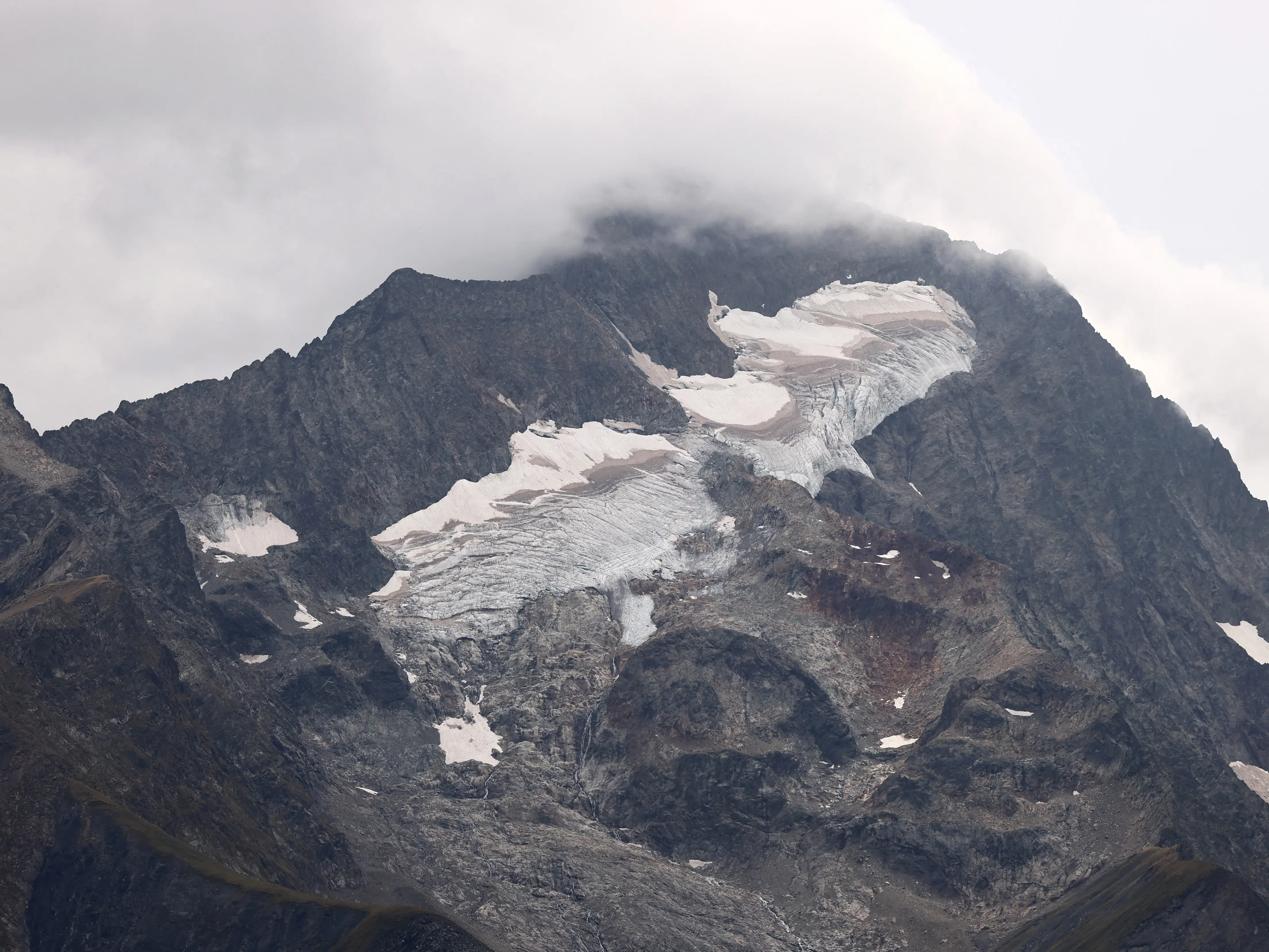 Alpine glacier was covered with sheep wool sheets to prevent melting. It worked Alpine glacier was covered with sheep wool sheets to prevent melting. It worked